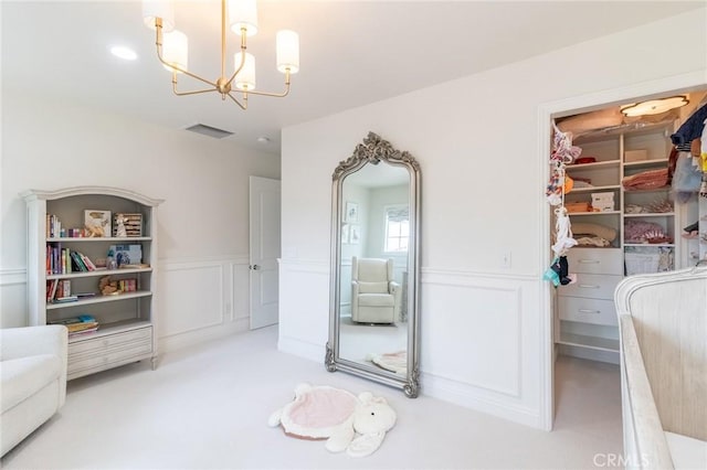 34072 Lily Rd, Yucaipa, CA 92399 - unfurnished bedroom with a chandelier, a decorative wall, wainscoting, a closet, and carpet