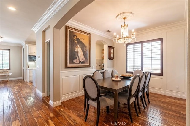 34072 Lily Rd, Yucaipa, CA 92399 - dining room with arched walkways, hardwood / wood-style flooring, a decorative wall, a chandelier, and ornamental molding