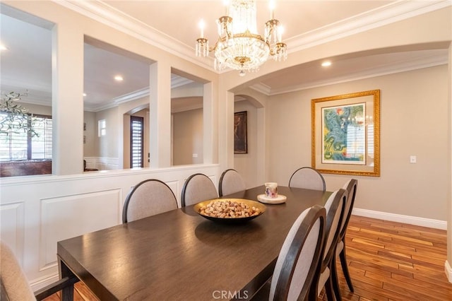 34072 Lily Rd, Yucaipa, CA 92399 - dining area featuring ornamental molding, hardwood / wood-style floors, a chandelier, arched walkways, and recessed lighting