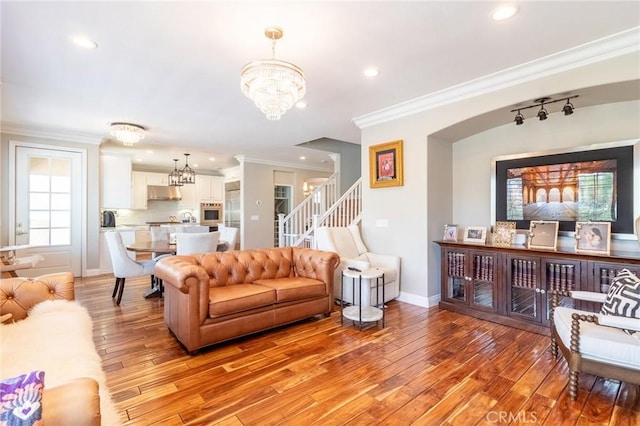 34072 Lily Rd, Yucaipa, CA 92399 - living room with a chandelier, light wood-style flooring, crown molding, stairs, and recessed lighting
