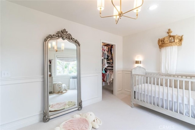 34072 Lily Rd, Yucaipa, CA 92399 - carpeted bedroom with a chandelier, a spacious closet, a closet, wainscoting, and a crib