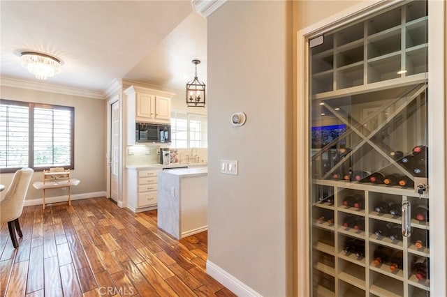 34072 Lily Rd, Yucaipa, CA 92399 - wine cellar featuring baseboards, crown molding, light wood-style flooring, and a sink