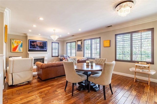 34072 Lily Rd, Yucaipa, CA 92399 - dining room featuring a chandelier, hardwood / wood-style flooring, recessed lighting, baseboards, and a fireplace