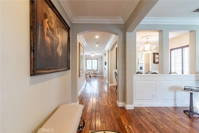 34072 Lily Rd, Yucaipa, CA 92399 - hallway with crown molding, arched walkways, wood-type flooring, a chandelier, and baseboards