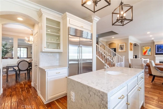 34072 Lily Rd, Yucaipa, CA 92399 - kitchen with built in refrigerator, a sink, a chandelier, arched walkways, and dark wood-style floors