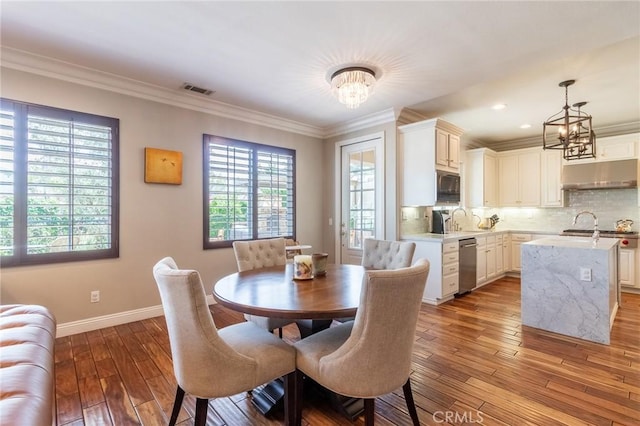 34072 Lily Rd, Yucaipa, CA 92399 - dining room with a chandelier, plenty of natural light, hardwood / wood-style flooring, ornamental molding, and recessed lighting