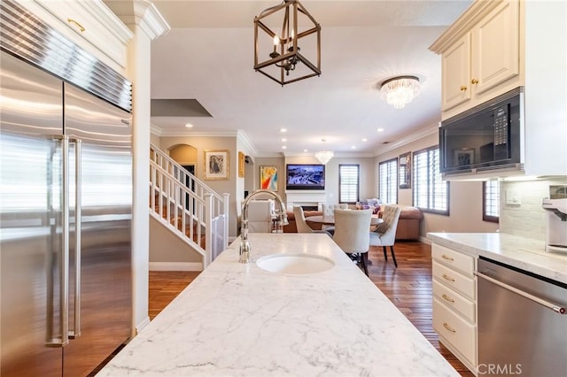 34072 Lily Rd, Yucaipa, CA 92399 - kitchen with built in appliances, a sink, a chandelier, dark wood-type flooring, and ornamental molding