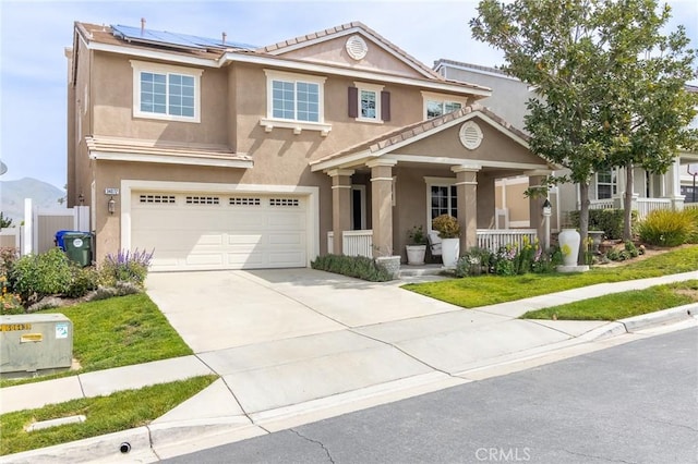 34072 Lily Rd, Yucaipa, CA 92399 - view of front of house featuring covered porch, stucco siding, a garage, solar panels, and concrete driveway