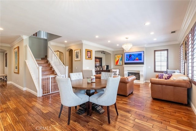 34072 Lily Rd, Yucaipa, CA 92399 - dining space featuring arched walkways, baseboards, wood finished floors, stairway, and recessed lighting