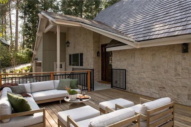 wooden terrace featuring outdoor lounge area