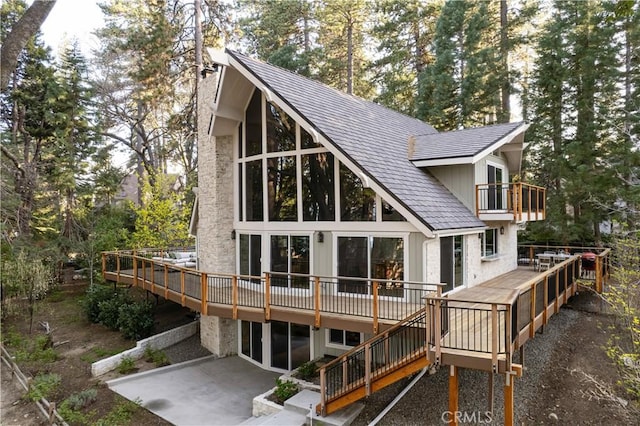 back of house with stairway, a patio, a wooden deck, and a balcony
