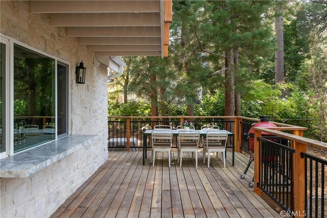 wooden terrace with outdoor dining space