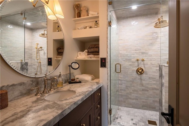 full bathroom with vanity, built in features, and a stall shower