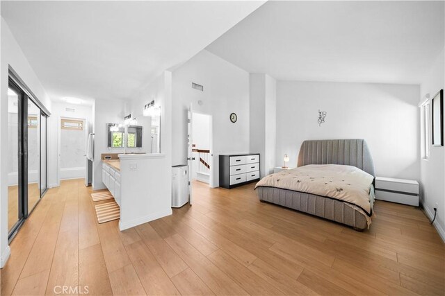bedroom with freestanding refrigerator, baseboards, visible vents, and light wood-type flooring