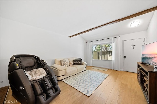 living room featuring vaulted ceiling with beams and light wood-style flooring