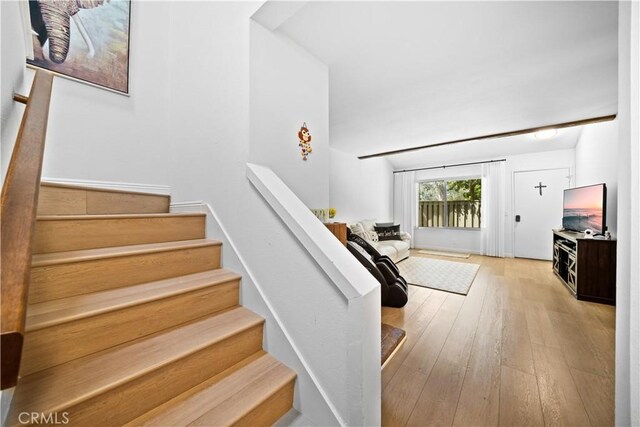 stairs featuring hardwood / wood-style floors