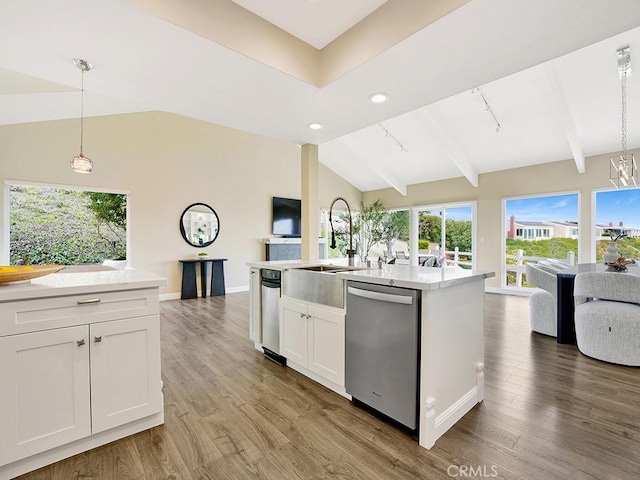 31062 Flying Cloud Dr, Laguna Niguel, CA 92677 - kitchen with white cabinets, a sink, open floor plan, vaulted ceiling with beams, and stainless steel dishwasher
