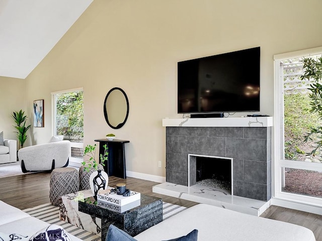 31062 Flying Cloud Dr, Laguna Niguel, CA 92677 - living room with baseboards, high vaulted ceiling, wood finished floors, and a tile fireplace