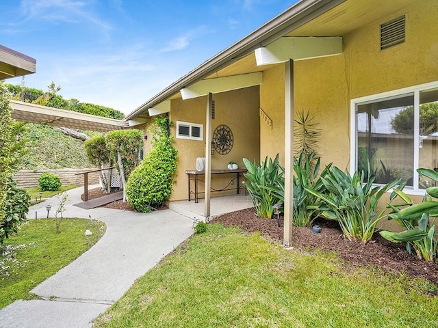 31062 Flying Cloud Dr, Laguna Niguel, CA 92677 - view of exterior entry featuring a lawn and stucco siding