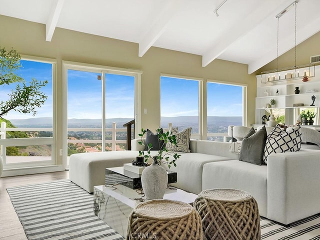31062 Flying Cloud Dr, Laguna Niguel, CA 92677 - living area with visible vents, lofted ceiling with beams, and light wood-style flooring