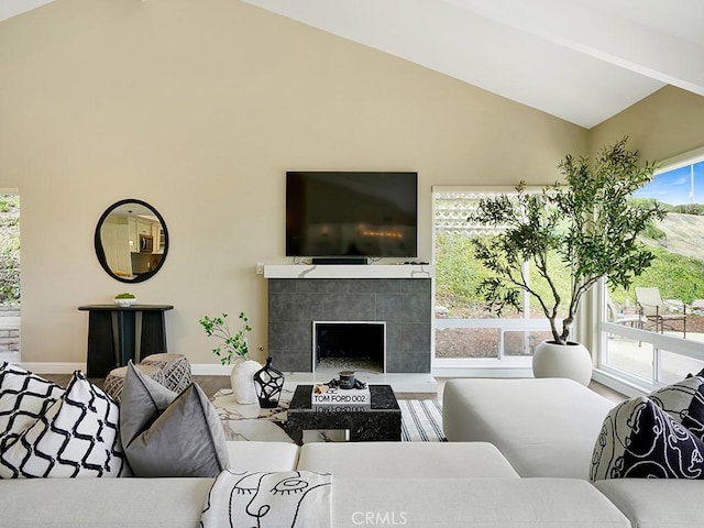 31062 Flying Cloud Dr, Laguna Niguel, CA 92677 - living room featuring a tiled fireplace, baseboards, wood finished floors, and high vaulted ceiling