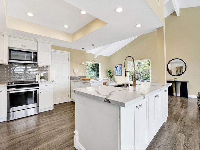 31062 Flying Cloud Dr, Laguna Niguel, CA 92677 - kitchen with white cabinets, backsplash, stainless steel appliances, and dark wood-type flooring