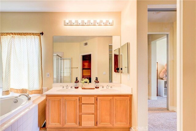 2438 Vista Del Sol Ln, Verne, CA 91750 - bathroom featuring visible vents, a sink, a bath, and a stall shower