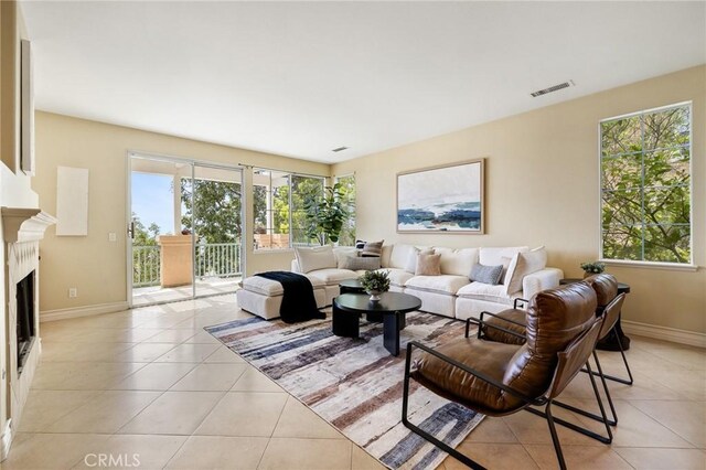 2438 Vista Del Sol Ln, Verne, CA 91750 - living room featuring light tile patterned flooring, baseboards, visible vents, and a fireplace