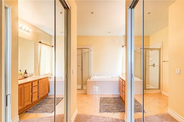 2438 Vista Del Sol Ln, Verne, CA 91750 - bathroom featuring a sink, double vanity, tile patterned floors, a bath, and a stall shower