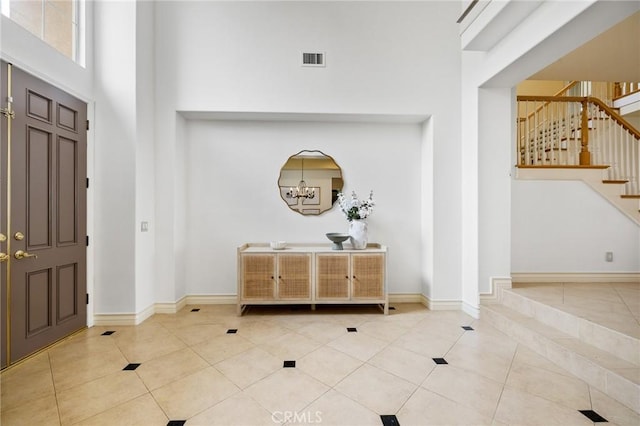 2438 Vista Del Sol Ln, Verne, CA 91750 - tiled foyer with visible vents, stairs, a towering ceiling, baseboards, and a chandelier