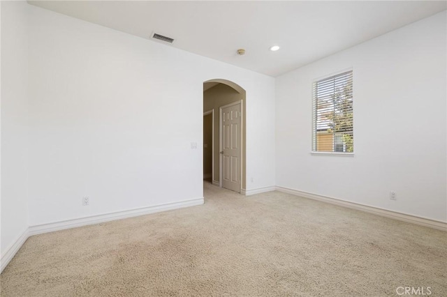 2438 Vista Del Sol Ln, Verne, CA 91750 - empty room with arched walkways, baseboards, visible vents, and light carpet