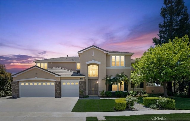 2438 Vista Del Sol Ln, Verne, CA 91750 - view of front facade featuring an attached garage, a front lawn, stucco siding, and driveway