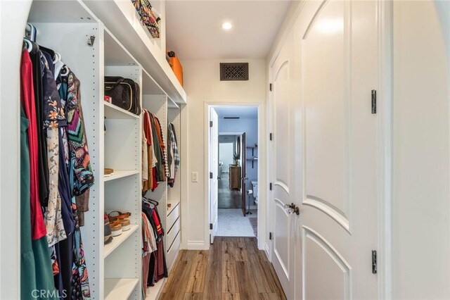 spacious closet featuring light wood finished floors and visible vents