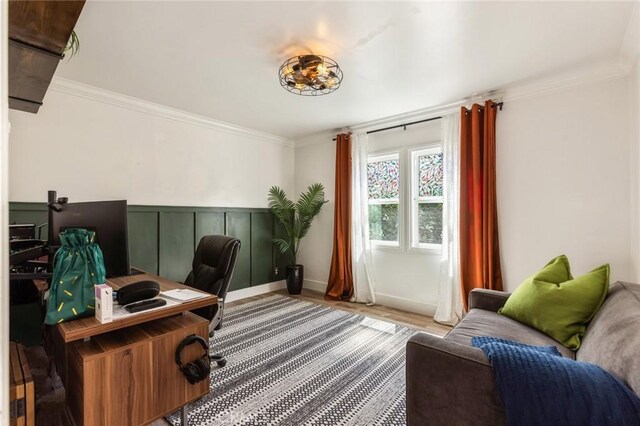 office with wainscoting, ornamental molding, and wood finished floors