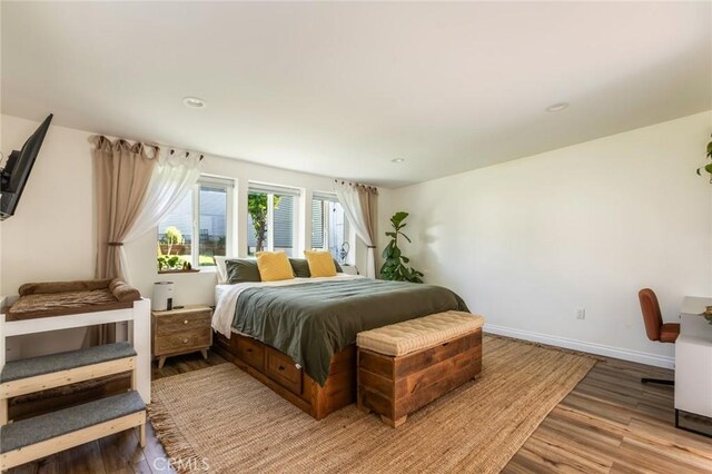 bedroom with light wood-type flooring, recessed lighting, and baseboards
