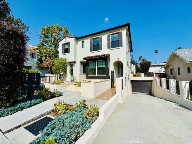 mediterranean / spanish-style house with stucco siding and a tiled roof