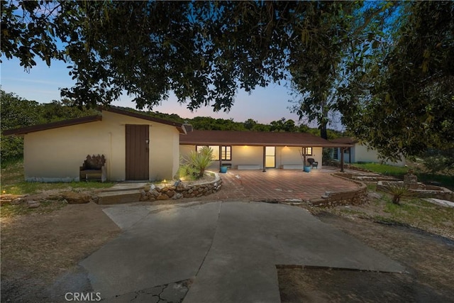 28015 Old Mine Rd, Ranchita, CA 92066 - view of front of house with stucco siding, an outdoor structure, and a patio area
