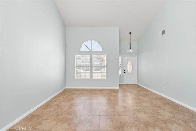 entryway featuring visible vents, baseboards, and high vaulted ceiling