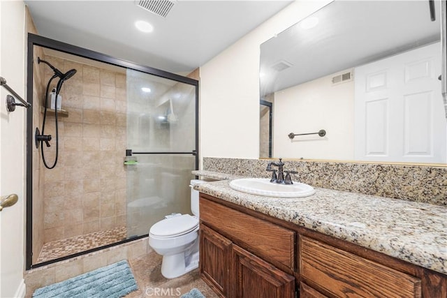 full bathroom with vanity, a stall shower, toilet, and visible vents