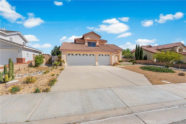 view of front facade featuring a garage, fence, stucco siding, a tiled roof, and driveway