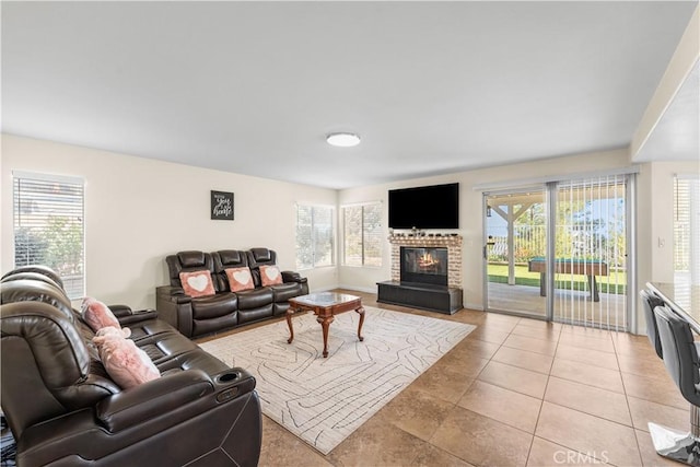 living room featuring light tile patterned floors and a fireplace