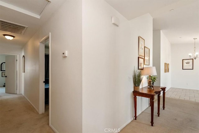 905 Broadway Ave, Barstow, CA 92311 - hallway featuring baseboards, light carpet, and visible vents