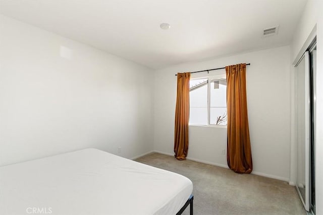 905 Broadway Ave, Barstow, CA 92311 - bedroom with baseboards, visible vents, light carpet, and a closet