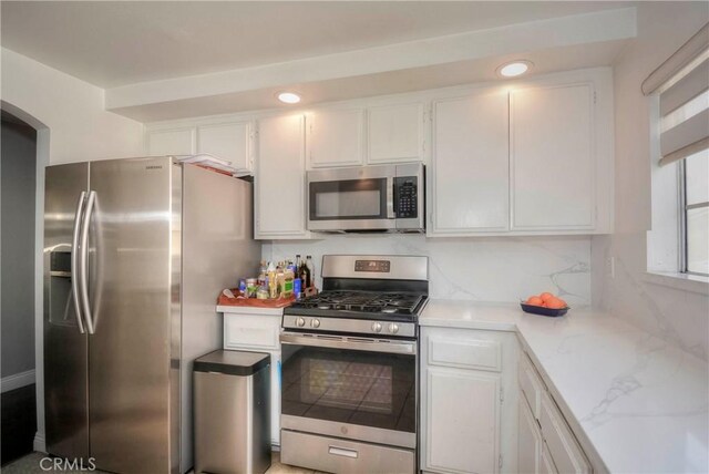 kitchen featuring white cabinets, stainless steel appliances, and recessed lighting