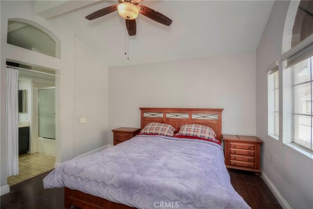 bedroom with baseboards, wood finished floors, and beam ceiling