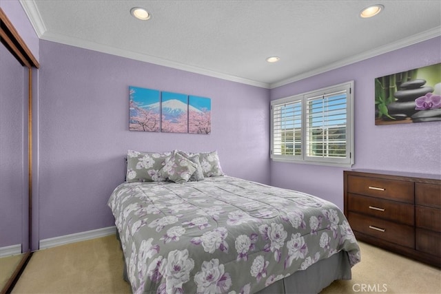 bedroom with light colored carpet, recessed lighting, baseboards, ornamental molding, and a closet