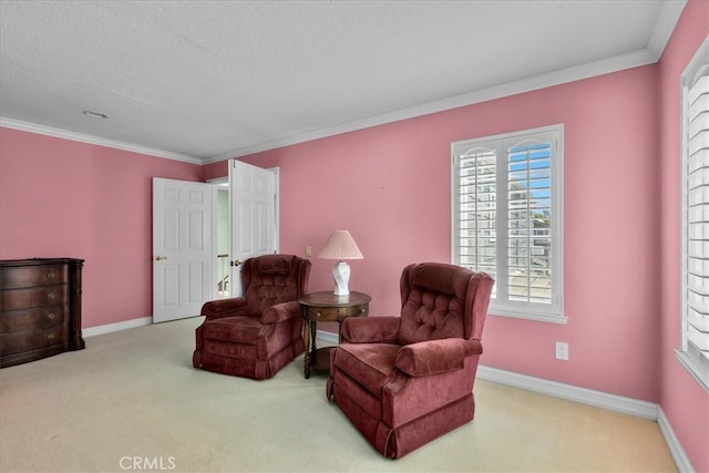 sitting room with carpet floors, ornamental molding, and baseboards