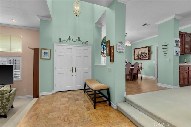 entrance foyer with crown molding, recessed lighting, baseboards, and visible vents