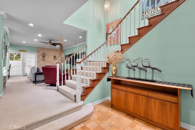staircase with recessed lighting, baseboards, ornamental molding, and ceiling fan