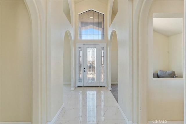 9170 Japatul Rd, Apple Valley, CA 92308 - foyer featuring arched walkways, baseboards, a towering ceiling, and marble finish floor